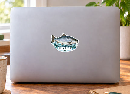 Maine Silver Fish Vinyl Sticker – 3 Inch shown on a laptop in a styled setting, with Seasonal Maine logo. Includes sticker only.