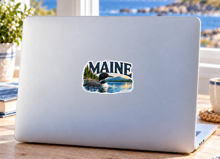 Maine Loon Lake Vinyl Sticker – 3 Inch shown on a laptop in a styled setting, with Seasonal Maine logo. Includes sticker only.