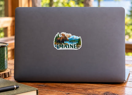Maine Moose & Mountain Lake Vinyl Sticker – 3 Inch shown on a laptop in a styled setting, with Seasonal Maine logo. Includes sticker only.