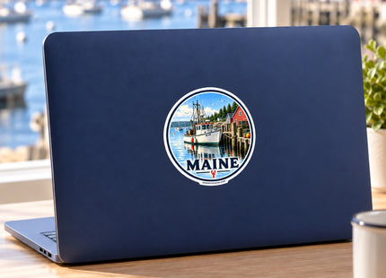 Maine Lobster Boat Harbor Vinyl Sticker – 3 Inch shown on a laptop in a styled setting, with Seasonal Maine logo. Includes sticker only.